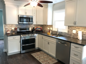 A newly remodeled kitchen featuring stainless steel appliances and white cabinets