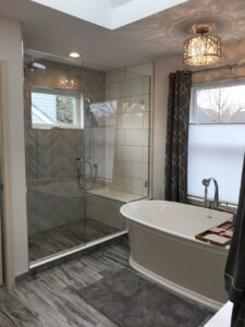 Picture of a shower and a bathtub in a newly remodeled bathroom.