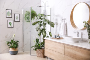Picture of a beautiful new bathroom with a glass shower enclosure, a vanity, and multiple potted plants.